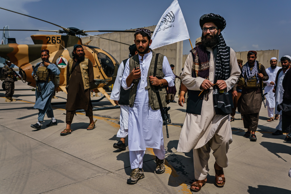 Taliban diplomaten inspecteren de achtergelaten Amerikaanse helikopters op de luchthaven van Kaboel - Afbeelding: Photonews